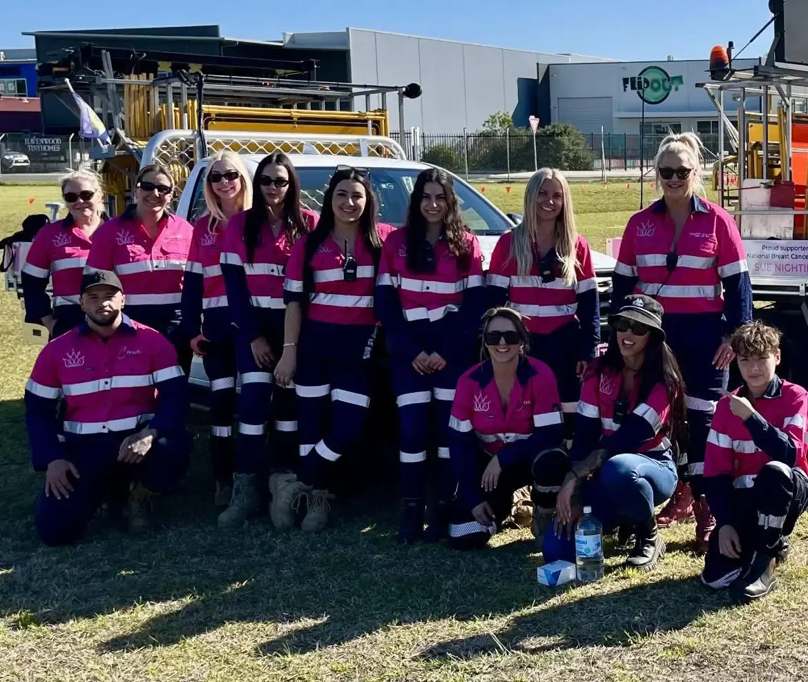 The Crown crew in pink hi-vis at an event